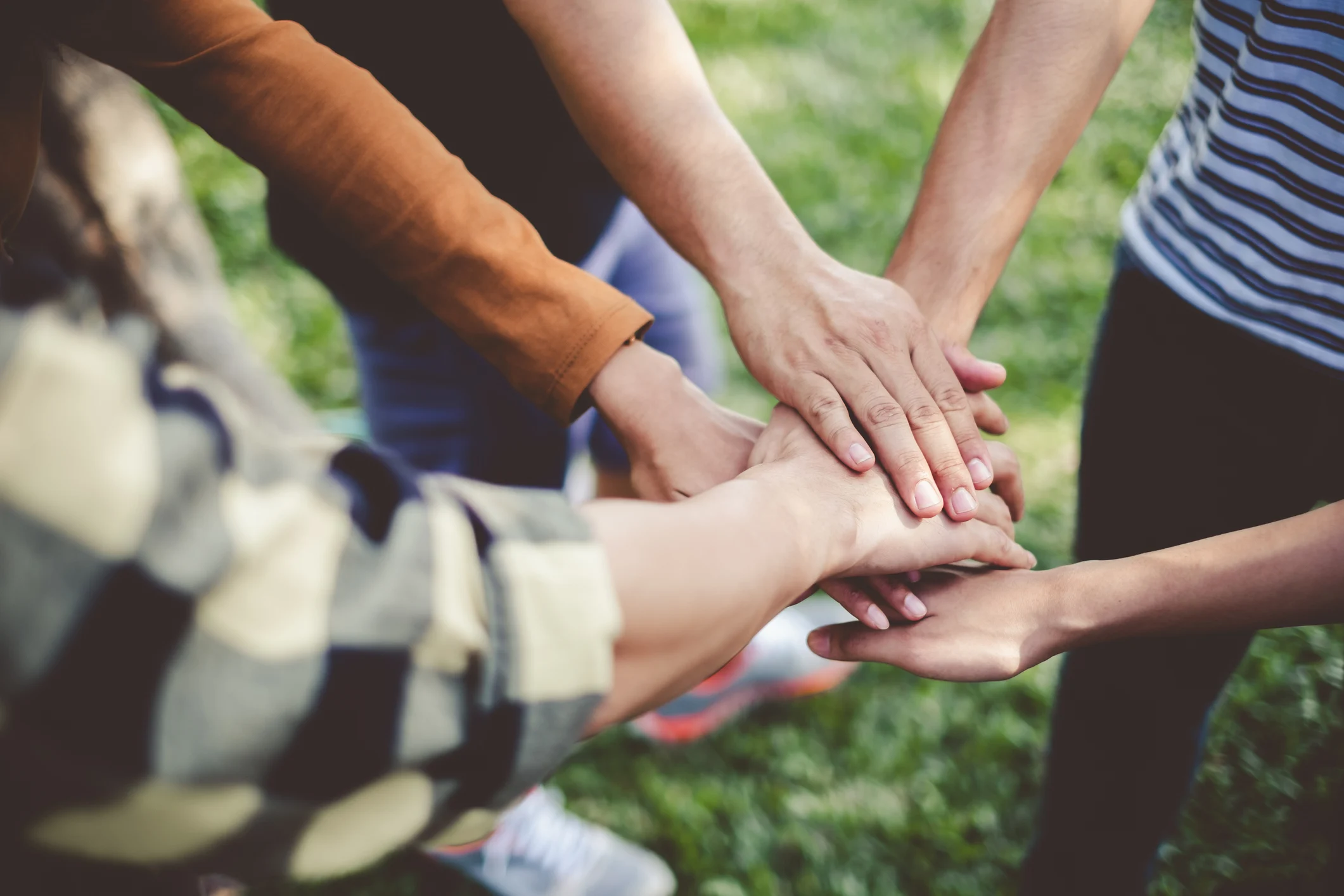 Hands joined together, representing the community programs Alta Dental supports
